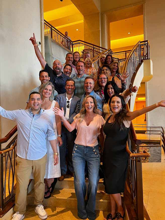 A group of EPIC agents celebrating together on a staircase